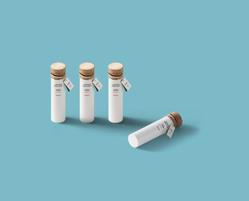 Four white bottles with cork lids.