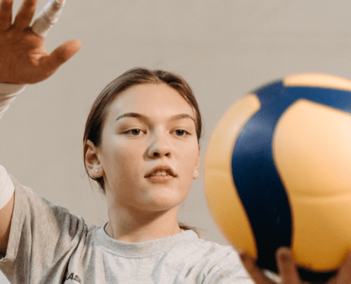 Girl preparing to serve a volleyball.