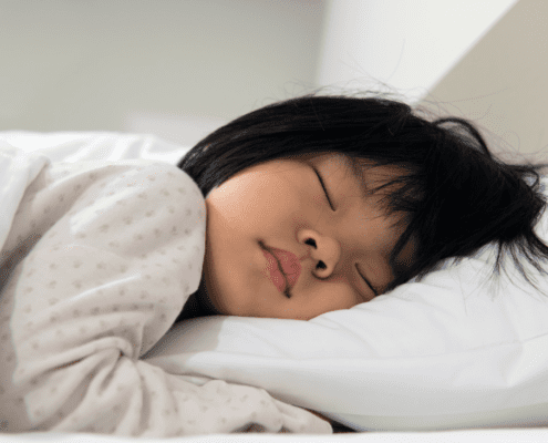 Child peacefully sleeping on a pillow.