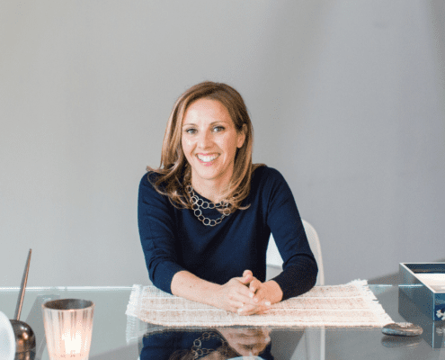 Smiling woman sitting at a desk.