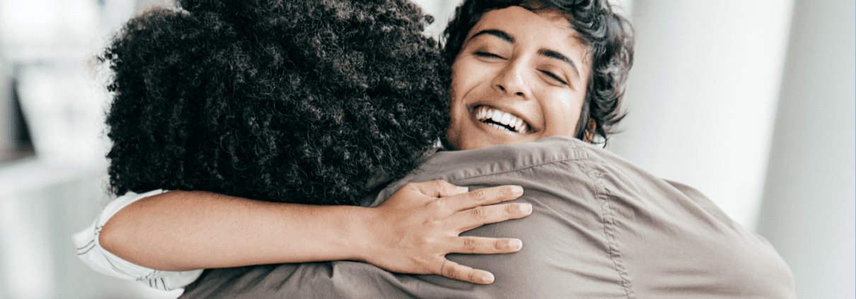 Two people embracing joyfully in happiness.