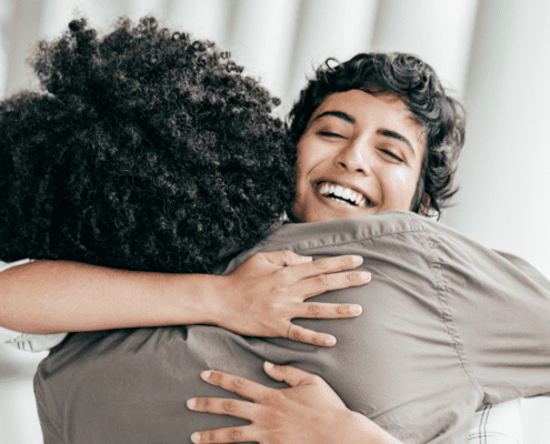 Two people embracing joyfully in happiness.