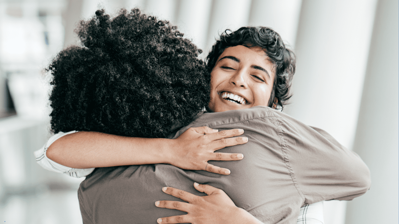 Two people embracing joyfully in happiness.