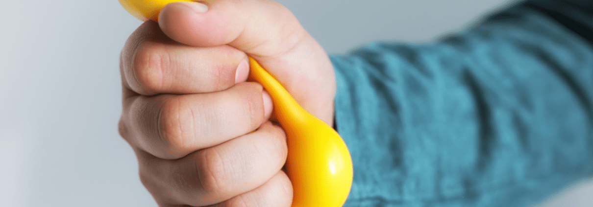 Hand holding a yellow dumbbell.