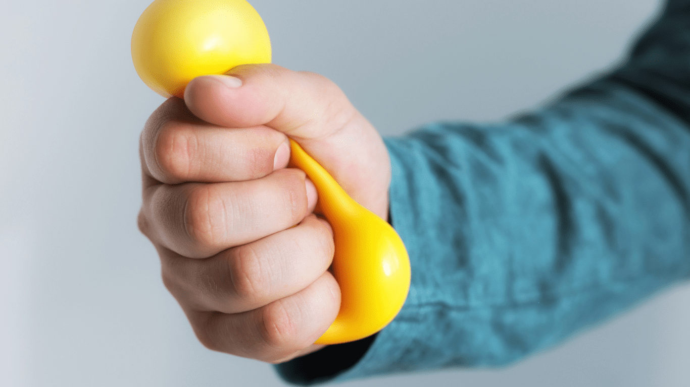 Hand holding a yellow dumbbell.