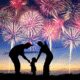 Family watching colorful fireworks in sky.