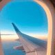 Airplane wing view at sunset from window.
