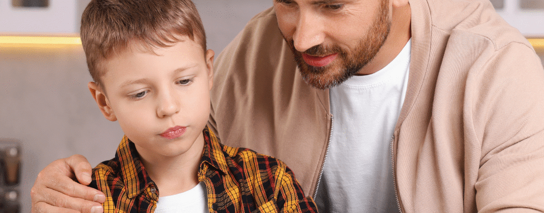 Father helping son with homework at table.