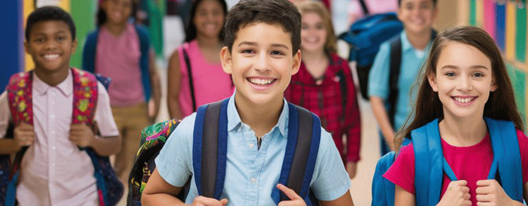 Students with backpacks walking in school hallway.
