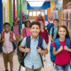 Students with backpacks walking in school hallway.