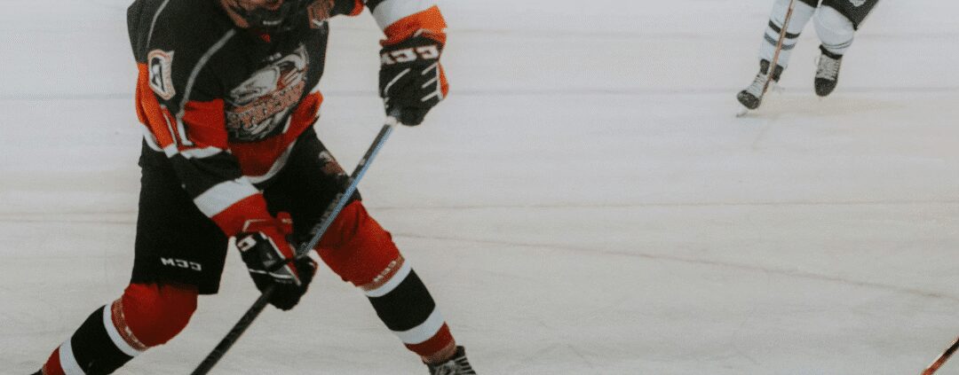 Ice hockey player in action on rink.