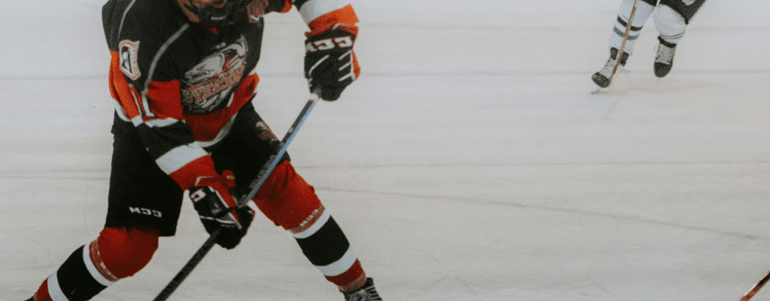 Ice hockey player in action on rink.