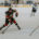 Ice hockey player in action on rink.