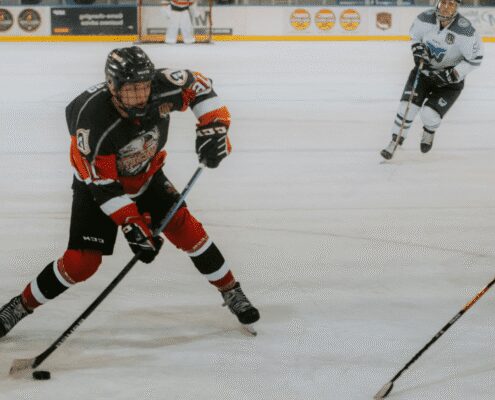 Ice hockey player in action on rink.