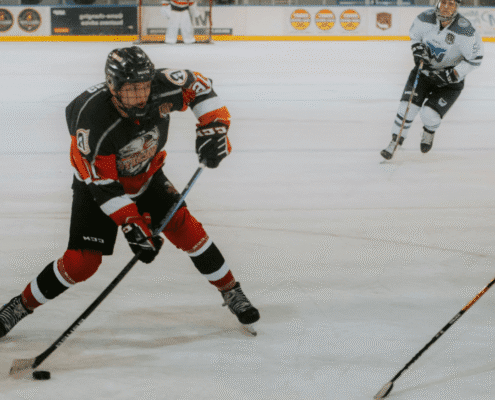 Ice hockey player in action on rink.