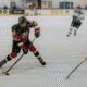 Ice hockey player in action on rink.