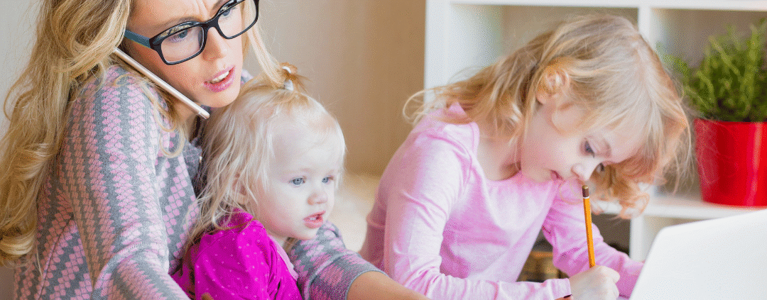 Mother multitasking with children at home.