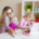 Mother multitasking with children at home.