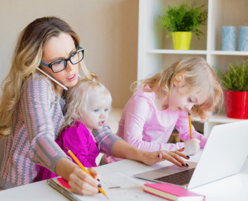Mother multitasking with children at home.