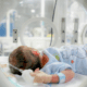 Newborn baby inside a hospital incubator.